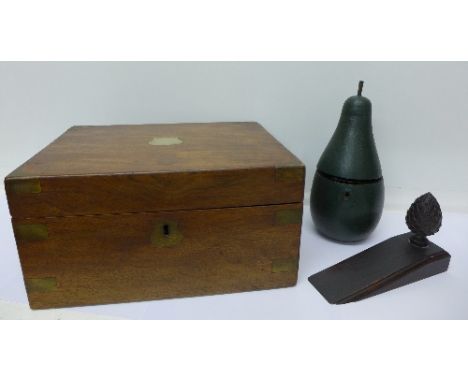 A pear shaped caddy, a mahogany door stop and a writing slope with ink bottle