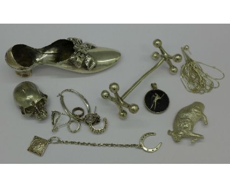 Silver including a horseshoe lapel St. Christopher, a shoe pin cushion, a knife rest and other items