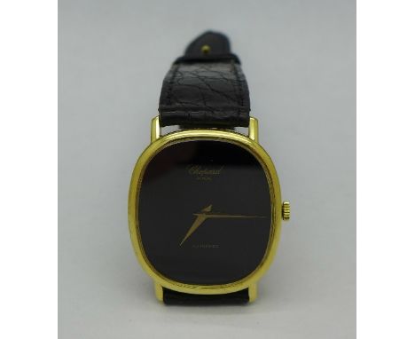 An 18ct gold cased Chopard automatic dress wristwatch with black dial, on a leather Patek Philippe strap with clasp marked C