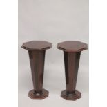 A PAIR OF ART DECO DESIGN WOODEN STANDS with octagonal tops. 2ft 6ins high.