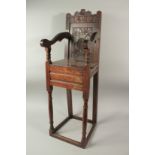 A CHILD'S 17TH CENTURY HIGH CHAIR, dated 1659, with carved back and solid seat. 3ft 6ins high x