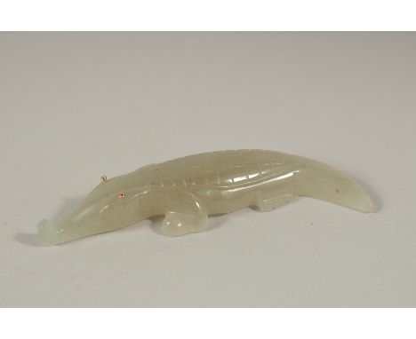 A RUSSIAN CARVED JADE CROCODILE with gold eyes. 11cms long, in a Faberge box.