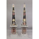 A GOOD PAIR OF COLOURED MARBLE OBELISKS ON STANDS. 6ft high.