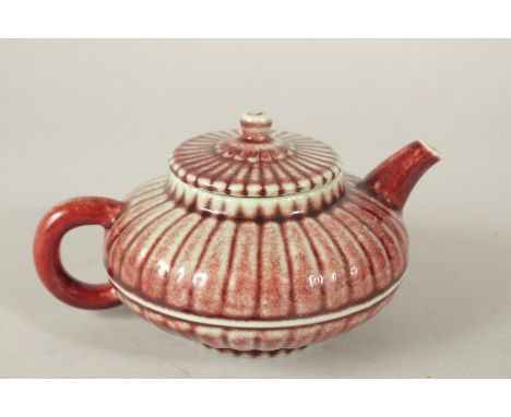 A CHINESE RED GLAZE PORCELAIN TEAPOT, the base with a character mark.