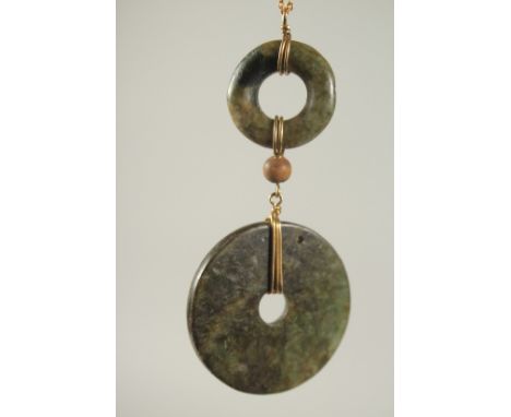 A CHINESE JADE LUCKY RING PENDANT AND CHAIN.