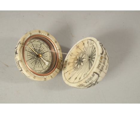 AN ETCHED BONE COMPASS. 6cms diameter.