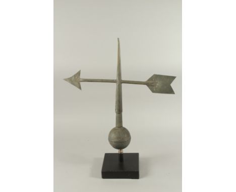 A METAL ARROW WEATHER VANE on a wooden base. 28ins high.