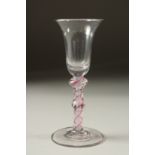 A GEORGIAN WINE GLASS with inverted bell bowl and colour twist stem. 5.5ins high.