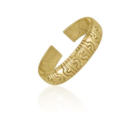 A GOLD CUFF BANGLEWith interlocking geometric modules, creating a flexible cuff bangle, in 18k gold, inner diameter approxima