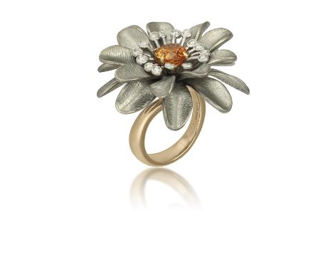 A GARNET, DIAMOND AND TITANIUM COCKTAIL RING, BY MARGHERITA BURGENERDesigned as a stylised flowerhead, set at the centre with