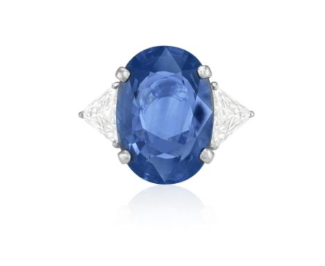 A SAPPHIRE AND DIAMOND DRESS RINGThe oval-shaped sapphire weighing 9.83cts within a four-claw setting, between triangle-cut d