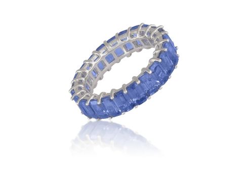 A SAPPHIRE ETERNITY RINGThe continuous row of rectangular-cut sapphires within claw-setting, mounted in 18K gold, numbered, s