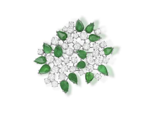 AN EMERALD AND DIAMOND BROOCH, CIRCA 1965The spray brooch set with brilliant-cut diamonds and pear-shaped emeralds, mounted i