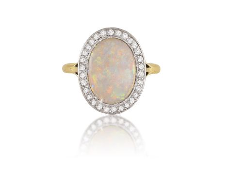 AN EARLY 20TH CENTURY OPAL AND DIAMOND DRESS RINGThe central oval-shaped opal cabochon within an old single-cut diamond surro