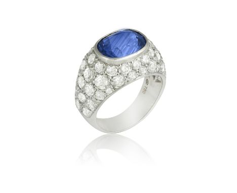 A SAPPHIRE AND DIAMOND DRESS RINGThe central oval-shaped sapphire within collet setting, to a brilliant-cut diamond surround,