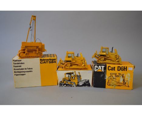 Three Conrad 1:50 scale Cat diecast models: 2872 Pipelayer 594; two 2851 Track-type Tractor D6H. G-VG, boxed. (3)