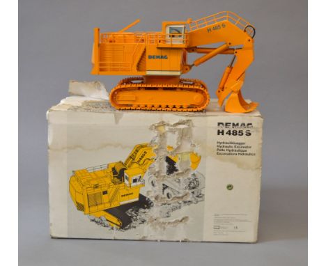 NZG 357 Demag H 485 S Hydraulic Excavator, yellow, 1:50 scale diecast model. G, some paint wear and in need of cleaning, boxe