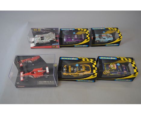 Six boxed 'Scalextric' and other slot cars, including C2453 TVR Tuscan 400R and a C2403 Ford GT40 missing the rear axle and w