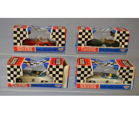 Slot Cars. Four Tri-ang Scalextric slot cars in early window boxes, two C74  Austin Healey models, one in red RN '5', the oth