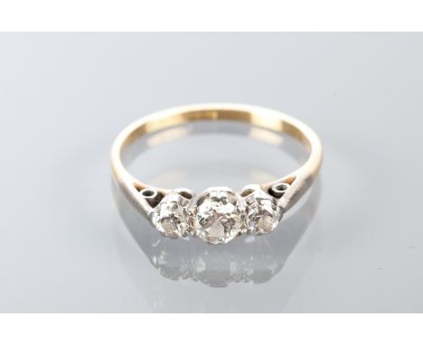 DIAMOND THREE STONE RING
set with three graduated diamonds totalling approximately 0.25 carats, in eighteen carat gold, size 
