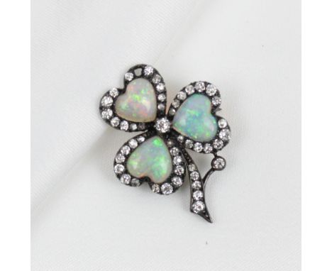 A 19th century opal and diamond clover brooch, the trio of heart shaped cabochon opals within a surround of mixed cut diamond