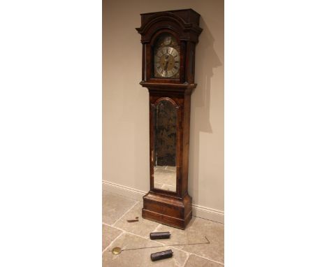 An early 18th century walnut cased eight day longcase clock signed 'William Tomlinson, London', the flat top hood with an arc