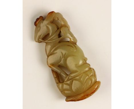 A Chinese carved jade 'Lu' pendant, 18th century or earlier, the celadon jade carving with russet hues carved to depicting a 