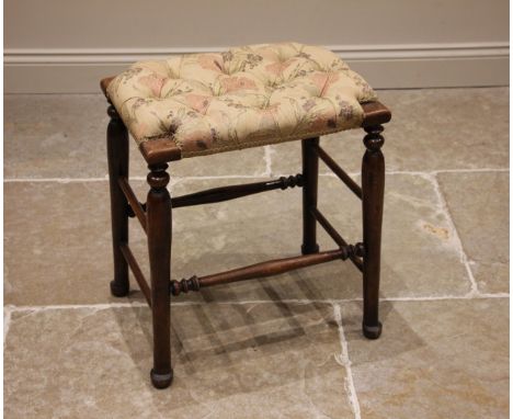 A stained beech wood and upholstered tall stool, early 20th century, the button down seat upon turned and tapering supports a