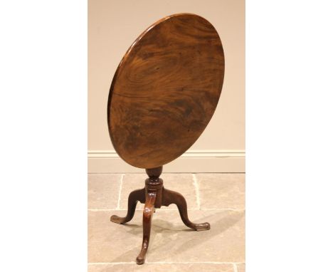 A George III mahogany tilt top tripod table, the polished circular top upon a gun barrel and cup pedestal, extending to three