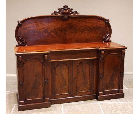 A Victorian mahogany chiffonier sideboard, the arched raised back with a lozenge and foliate crest extending to moulded 'C' s