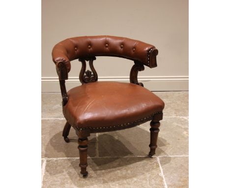 A Victorian walnut library chair, in the manner of Holland & Sons, the padded button back armrest supported on a central open