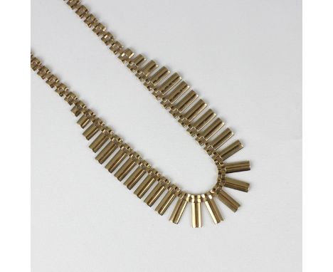 A yellow metal fringe necklace, the rectangular tapered fringe leading to gate link chain, with hidden box and tongue fastene
