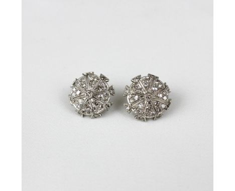 A pair of early 20th century diamond earrings, the central diamond set within Art Deco style lobed design with further surrou