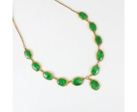 A Chinese yellow metal 'jade' necklace, composed of ten graduated oval panels, suspending further oval panel, closed to the r