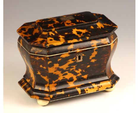 A Regency tortoiseshell tea caddy, of bombe form, the hinged cover centered with a monogrammed cartouche opening to twin lidd