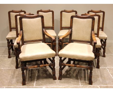 A set of eight continental style oak dining chairs, early 20th century, later re-upholstered and applied with stud detail, th