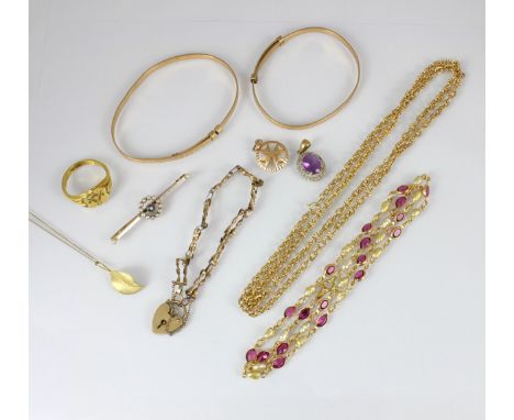 A selection of yellow metal and gold coloured jewellery, including a 9ct gold gate link bracelet, suspending heart shaped pad
