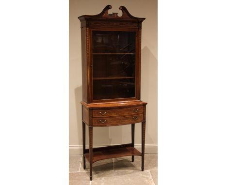 An Edwardian mahogany and satinwood banded display cabinet on stand, by Edwards and Roberts, the twin swan neck pediment over