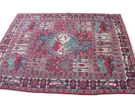 A vintage Tabriz carpet with a bespoke zoomorphic and garden all over panel design, in unique colourways, 395cm x 290cm