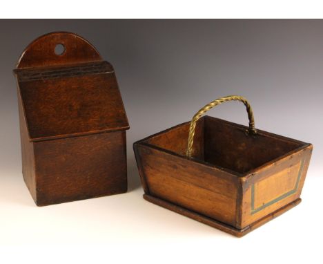 An 18th century oak candle box, the demi lune back board with central circular aperture over the hinged and sloping compartme