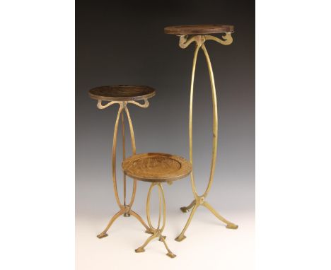A graduated set of three Art Nouveau shop display stands, possibly for Harris & Sheldon Ltd, each raised on sinuous brass tri