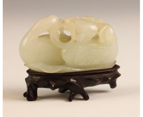A Chinese pale celadon Jade 'Duck and Lotus' carving, 18th century, modelled as a Mandarin duck with its head turned back gra