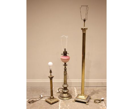 An ecclesiastical brass lamp base, late 19th century, the pink glass reservoir upon a tapering octagonal column extending to 