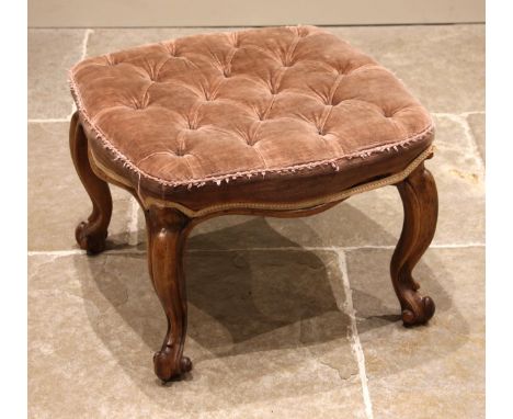 A 19th century walnut footstool, the pink velour button down seat upon French cabriole legs extending to scrolled feet, 40cm 