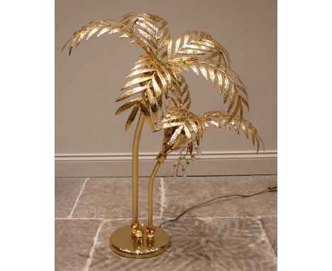 A Hollywood Regency freestanding gilt metal table or floor lamp, late 20th century, the two light stems formed as palm trees 