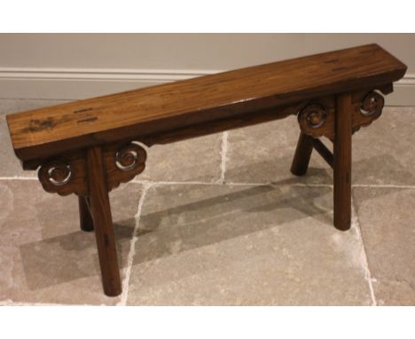 A Chinese hardwood hall bench, 20th century, the slab top upon tapering and splayed cylindrical legs united by scroll spandre