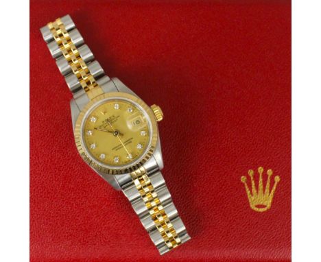 A ladies bi-metal Rolex oyster perpetual datejust wristwatch, the circular champagne dial set with ten round cut diamond mark