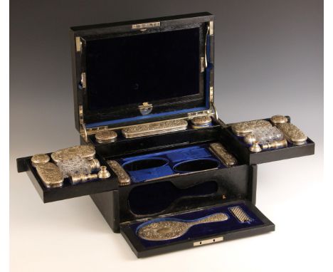 A Victorian silver mounted travelling vanity case, Charles Fox and Co Ltd, London 1890/91, the leather case with hinged cover