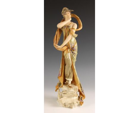 An Austrian porcelain figure by Ernst Wahliss, early 20th century, modelled as a lady calling out from a naturalistic rocky g