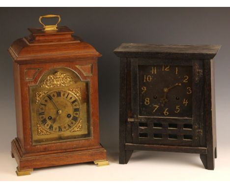 A walnut cased bracket clock, late 19th/early 20th century, the caddy form case enclosing the 17cm brass break arch dial and 